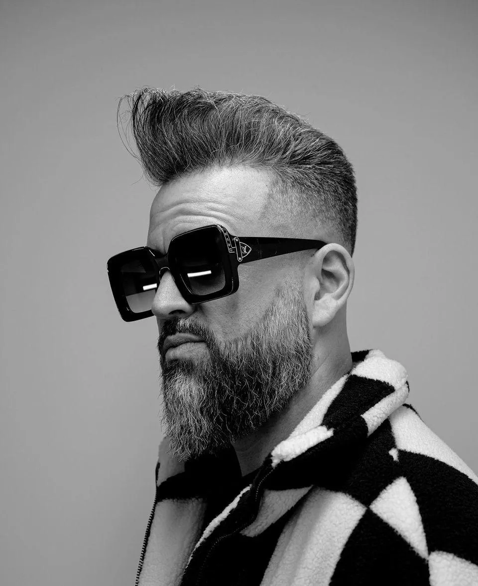 very handsome man with perfect hair and incredibly well curated sunglasses